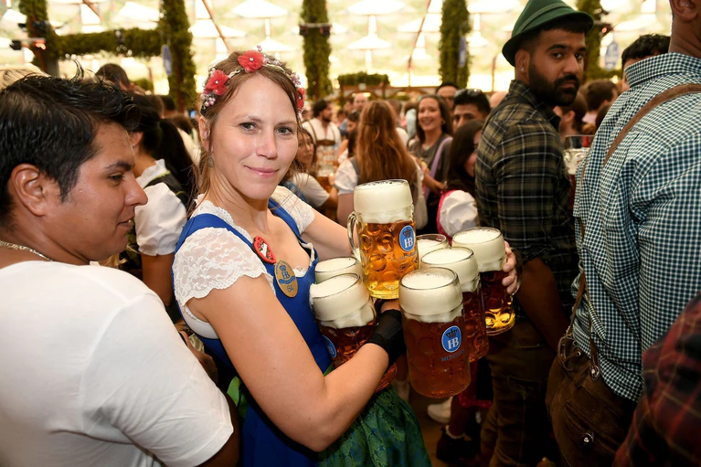 Die Bedienungen auf der Wiesn haben es nicht leicht (Archivbild). — © Felix Hörhager/dpa