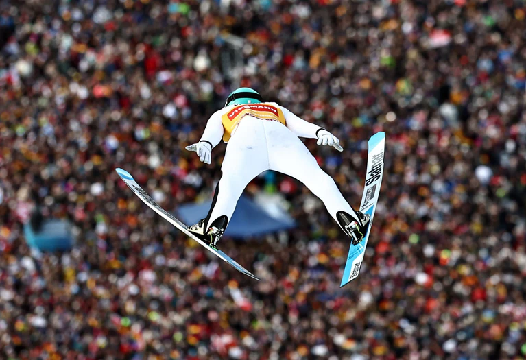 Domen Prevc glänzt vor voller Kulisse. — © Daniel Karmann/dpa